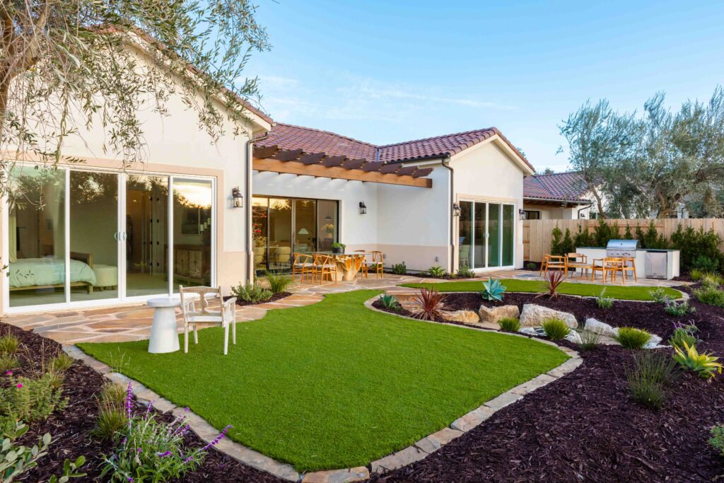 Modern backyard with landscaped garden and patio area.