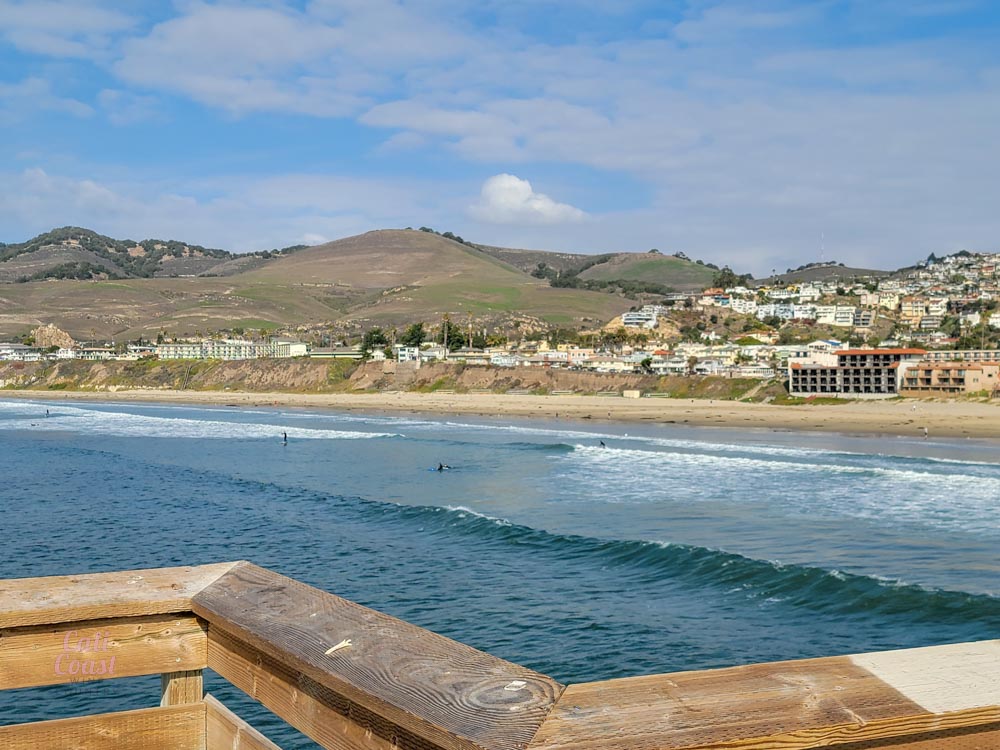 Scenic coastal city view with mountains and ocean.