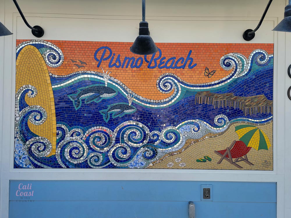 Pismo Beach mosaic with dolphins and beach scene.